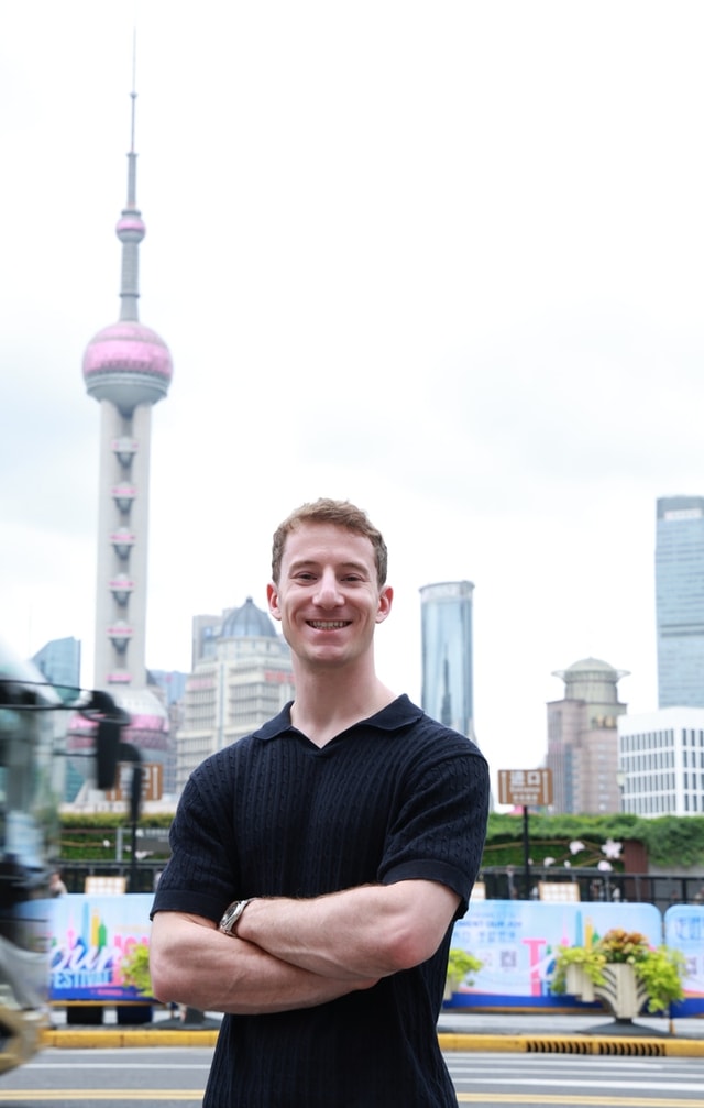 Zach W. in Shanghai, with the Oriental Pearl Tower in the background